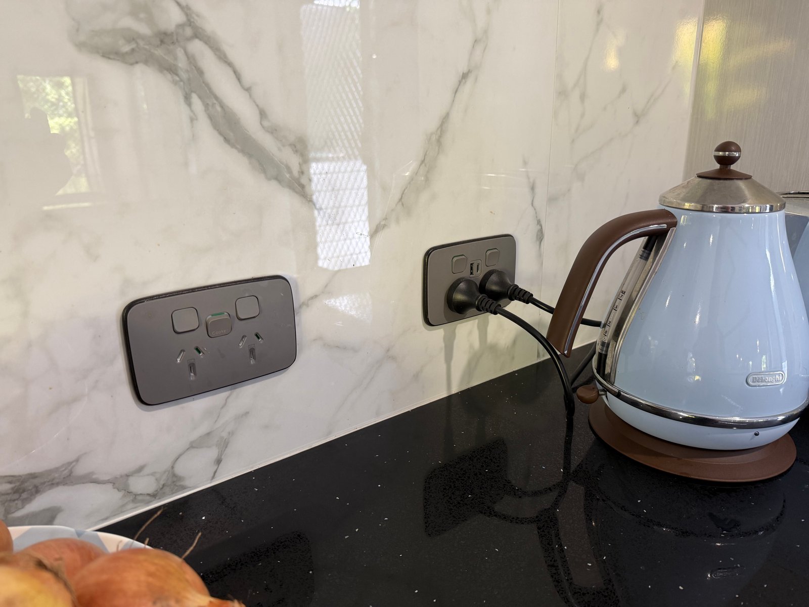 Black power point installation on stone splashback